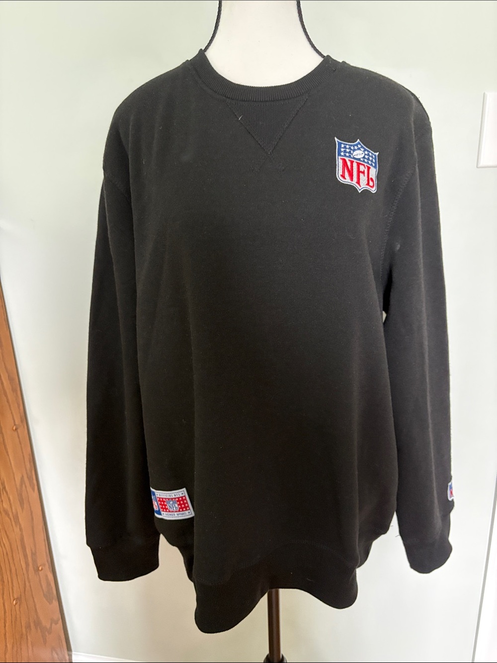 NFL Black Crewneck Sweatshirt with Embroidered Shield Patch